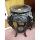 A CHINESE EBONIZED HARDWOOD STAND with circular top and carved lower detail and under tier shelf, 76
