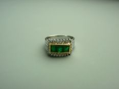 A FOURTEEN CARAT WHITE GOLD EMERALD & DIAMOND DRESS RING having three square faceted yellow green