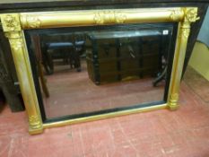 A 19th CENTURY EMPIRE STYLE GILT OVERMANTEL MIRROR with baton and acanthus leaf decoration, reeded