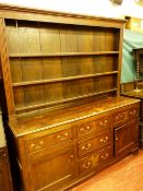 AN ANTIQUE OAK DENBIGHSHIRE STRAIGHT FRONT WELSH DRESSER, the wide boarded three shelf rack with