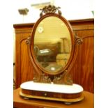 A VICTORIAN MAHOGANY SWING DRESSING MIRROR, oval framed with carved top detail and supports on an