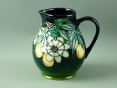 A MOORCROFT 'PASSION FRUIT' BULBOUS JUG, 14.5 cms high, decorated on a tonal green ground, impressed