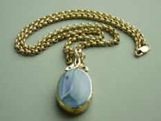 A NINE CARAT GOLD AGATE & BLUE GOLDSTONE OVAL PENDANT in an attractive mount and having a 60 cms