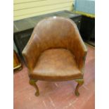 A VINTAGE OAK & LEATHER ARMCHAIR with steel button edging having a brass presentation plaque at