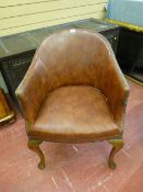 A VINTAGE OAK & LEATHER ARMCHAIR with steel button edging having a brass presentation plaque at