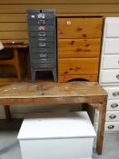A three-drawer pine bedside cabinet, small metal ten-drawer filing cabinet, painted wooden box and