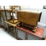 A neat vintage oak drop leaf side table together with a TV cabinet and two other tables