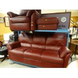A good quality modern dark red leather three seater sofa together with a matching armchair &