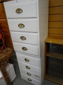 A pair of white painted four-drawer cabinets