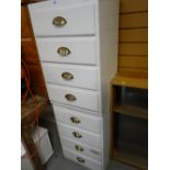 A pair of white painted four-drawer cabinets