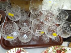 A tray of various cut glass drinking glasses