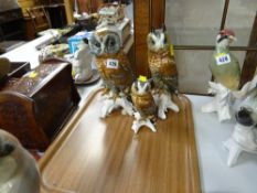 Three continental owl figures