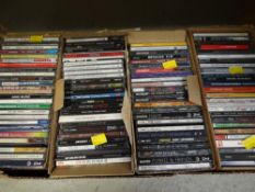 A box of approximately one hundred various pop CDs including Miles Davies, Stray Cats, Bryan Eno