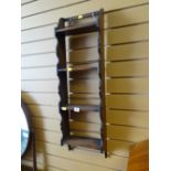 A mahogany narrow hanging shelf unit