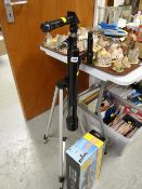 A Celestron telescope together with a boxed National Geographic 50mm astronomical telescope