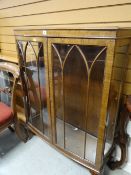 A vintage bow-fronted glazed display cabinet