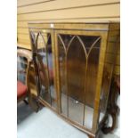 A vintage bow-fronted glazed display cabinet