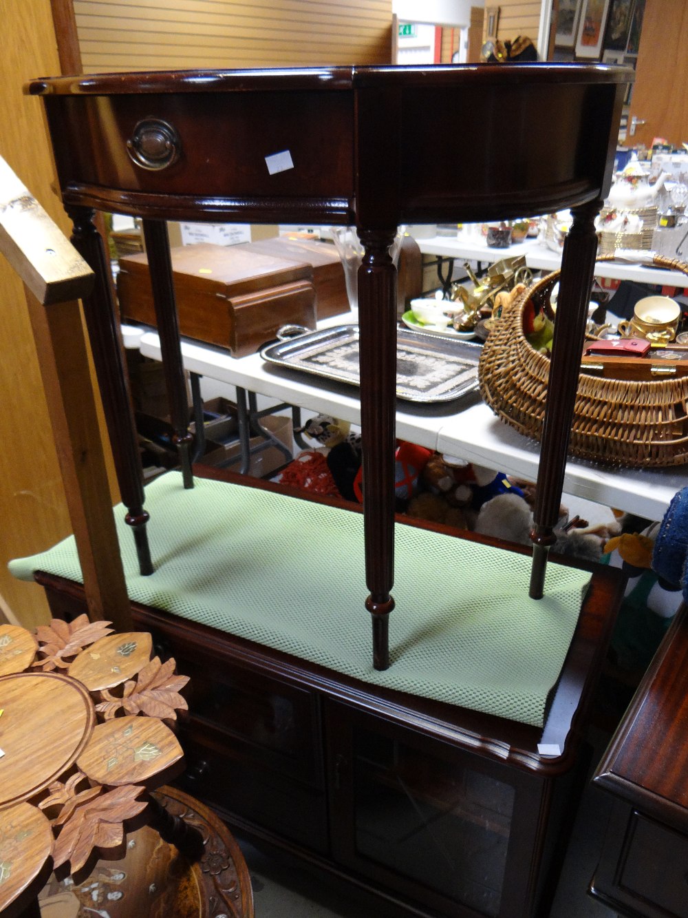 Mahogany effect shaped topped hall table together with a darkwood TV / hi-fi cabinet