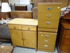 A neat vintage lightwood two cupboard two-drawer cabinet together with two bedside cupboards