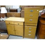 A neat vintage lightwood two cupboard two-drawer cabinet together with two bedside cupboards