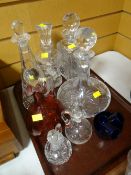 Four crystal decanters, cranberry glass decanter etc