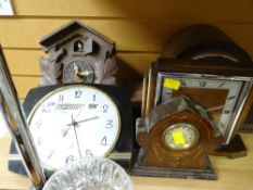 A parcel of five clocks including a cuckoo clock, retro day & date wall clock, oak domed mantel