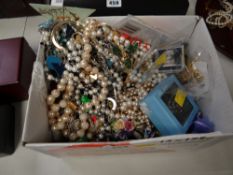 A box of various costume jewellery, badges, brooches, beads etc