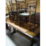 A good dark oak refectory-style dining table together with a set of six matching ladder back and