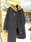 A fur collared Astrakhan coat together with another fur coat