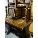 A vintage darkwood extending dining table and three matching chairs