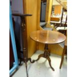 A nice antique oak tilt-top occasional table on tripod feet together with a modern reproduction