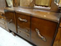 A vintage darkwood sideboard with two side cupboards and central drawers