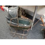 A Victorian child`s doll`s pram with green leather padded sprung carriage
