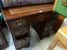 A good neat small reproduction mahogany ladies' kneehole desk by Morris