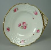 A NANTGARW FAN-HANDLED DISH moulded with c-scrolls, flowers and wreaths and painted with sprigs of