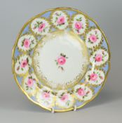 A NANTGARW PLATE DECORATED WITH ROSES the open flowers and stock in a series of twelve oval panels