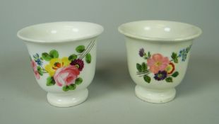 A PAIR OF (BELIEVED) SWANSEA CACHE-POTS having flared rims and painted with sprays of flowers,