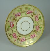 A SWANSEA PORCELAIN PLATE of circular form, of pale yellow ground, decorated with a series of closed