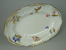 A NANTGARW PORCELAIN OVAL DISH moulded with c-scrolls, flowers and wreaths, the border painted