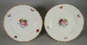 A PAIR OF NANTGARW PORCELAIN PLATES painted with a central spray of flowers and four sprigs to the