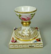 BELIEVED NANTGARW PORCELAIN EGG CUP (UNRECORDED SHAPE) on a square base, painted with flowers at