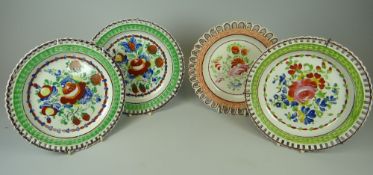 FOUR SMALL CAMBRIAN POTTERY PLATES with arcaded borders and primitive paintings of fruit and