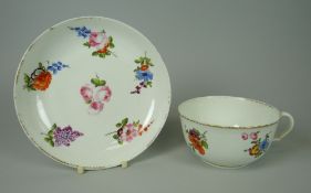 A SWANSEA CUP & SAUCER of plain form and painted with flowers, circa 1800