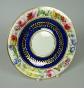 A SWANSEA PORCELAIN CUP STAND the border painted with a continuous circle of colour flowers, the