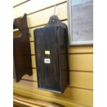 An antique oak hanging candle box