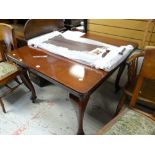 An antique mahogany extending dining table