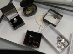 A parcel of white metal charms, dress rings etc