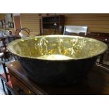 A very large antique brass cheese pan