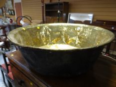 A very large antique brass cheese pan