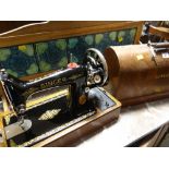 A vintage Singer sewing machine in case